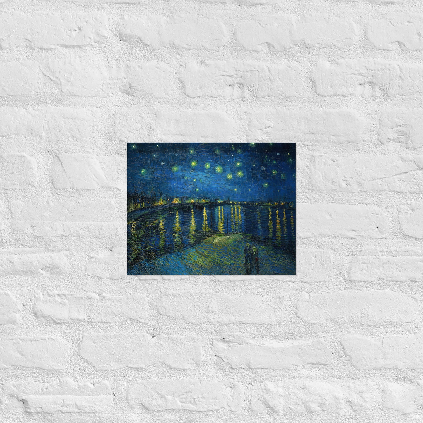 Van Gogh's 'Starry Night Over the Rhone' on a 11"x14" unframed poster print on a white brick wall.
