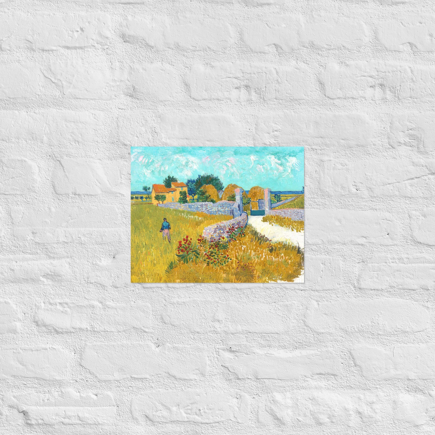 Van Gogh's 'Farmhouse in Provence' on a 11"x14" unframed poster print on a white brick wall.