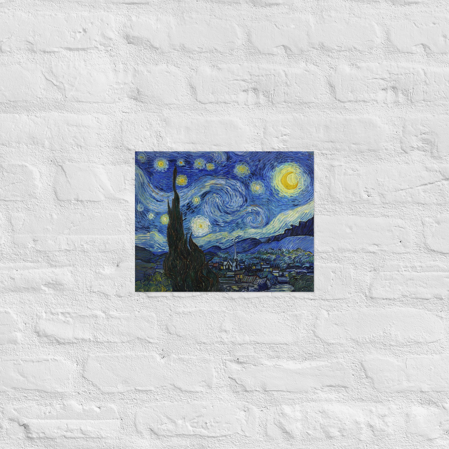 Van Gogh's 'Starry Night' on a 11"x14" unframed poster print on a white brick wall.