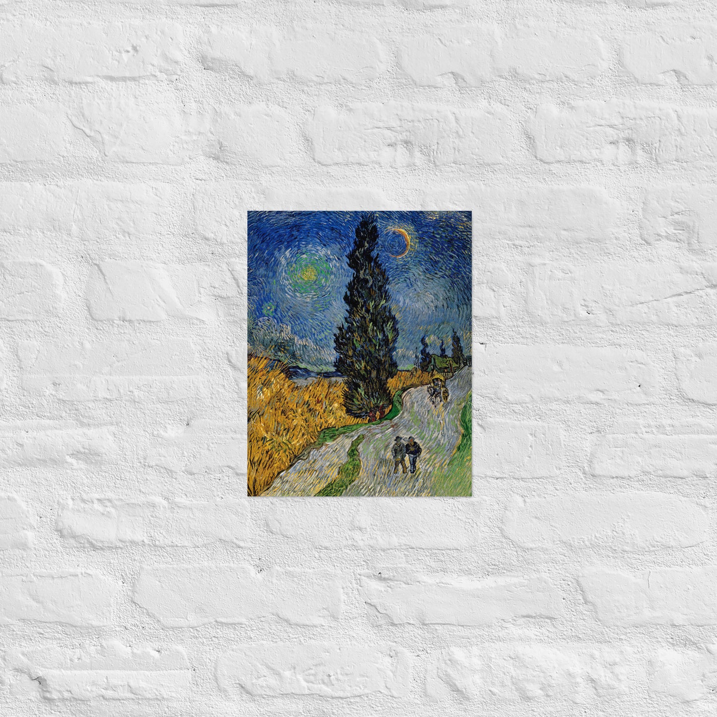 Van Gogh's 'Road with Cypress and Star' on a 11"x14" unframed poster print on a white brick wall.
