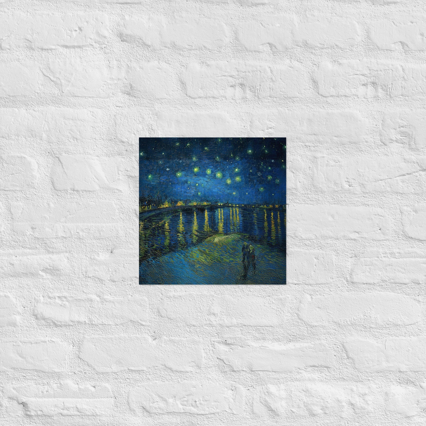 Van Gogh's 'Starry Night Over the Rhone' on a 12"x12" unframed poster print on a white brick wall.