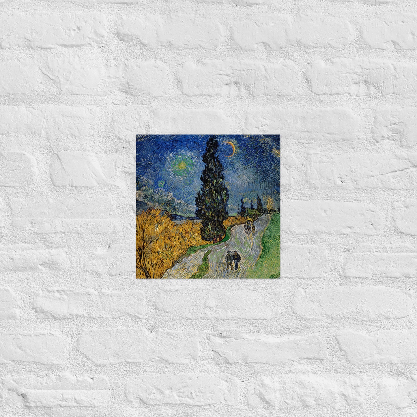 Van Gogh's 'Road with Cypress and Star' on a 12"x12" unframed poster print on a white brick wall.