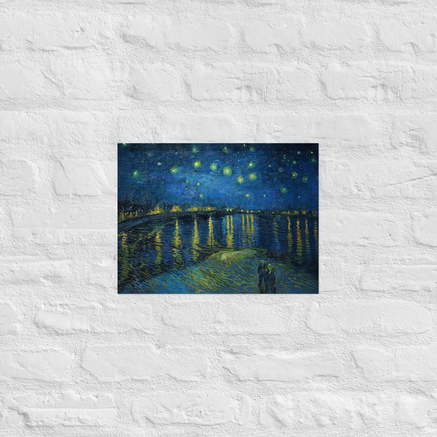 Van Gogh's 'Starry Night Over the Rhone' on a 12"x16" unframed poster print on a white brick wall.