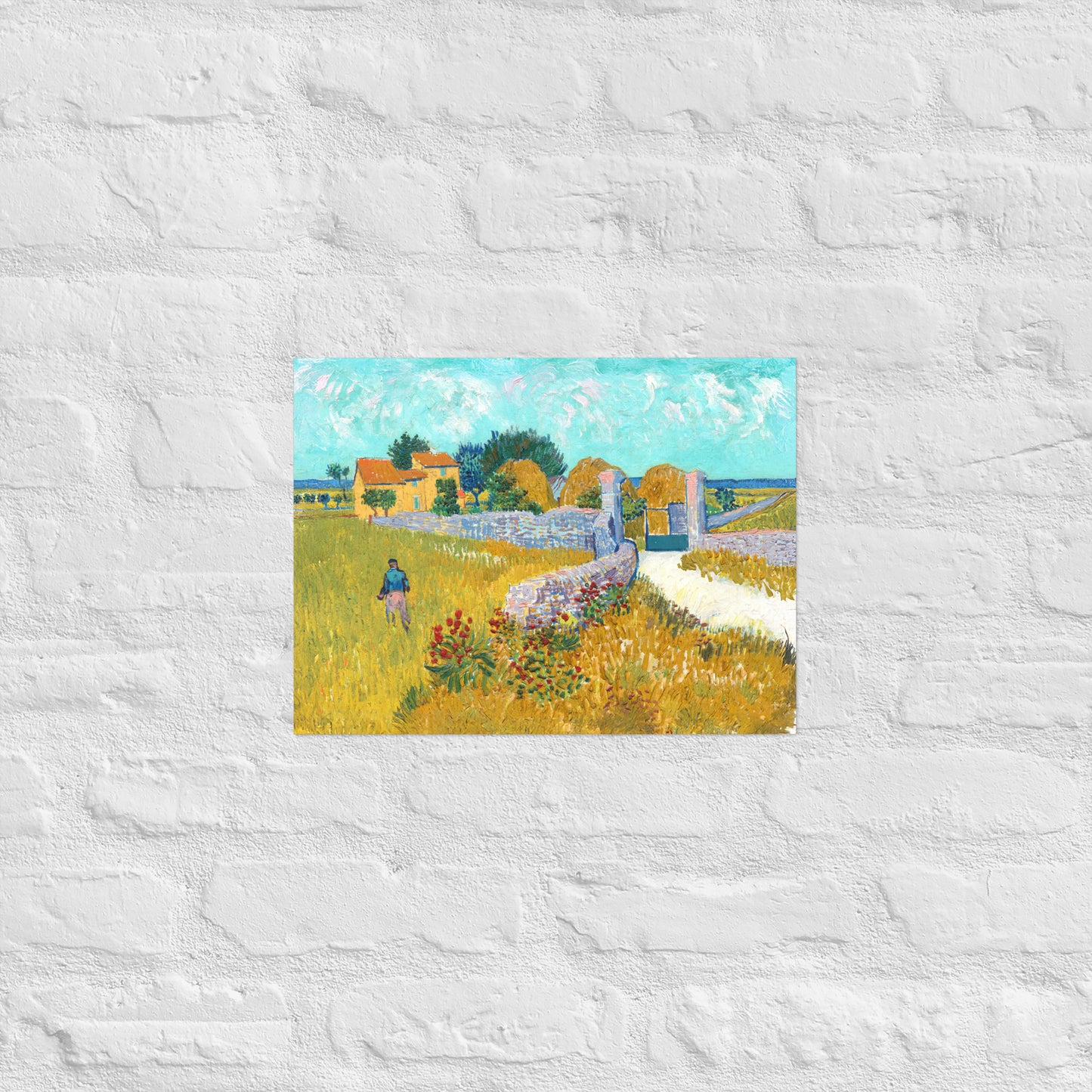 Van Gogh's 'Farmhouse in Provence' on a 12"x16" unframed poster print on a white brick wall.