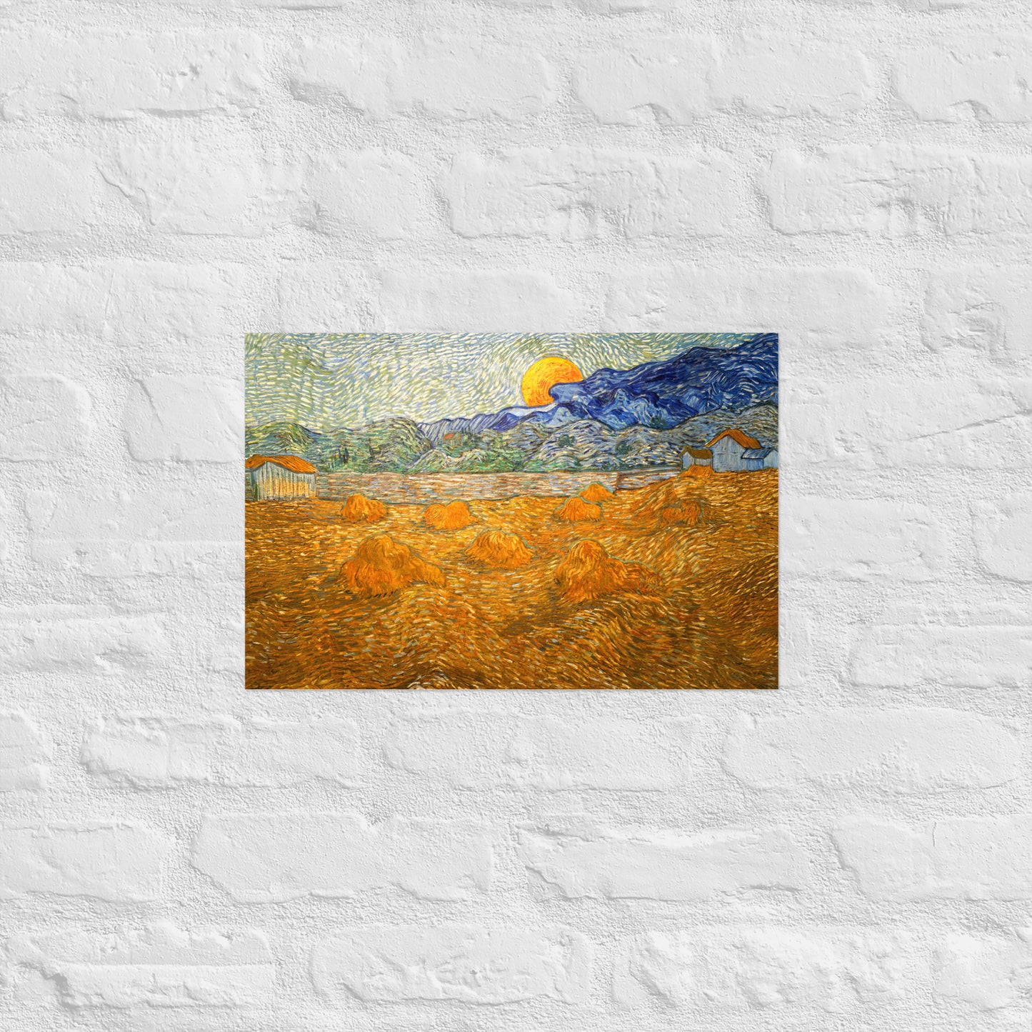 Van Gogh's 'Landscape with Wheat Sheaves and Rising Moon' on a 12"x18" unframed poster print on a white brick wall.