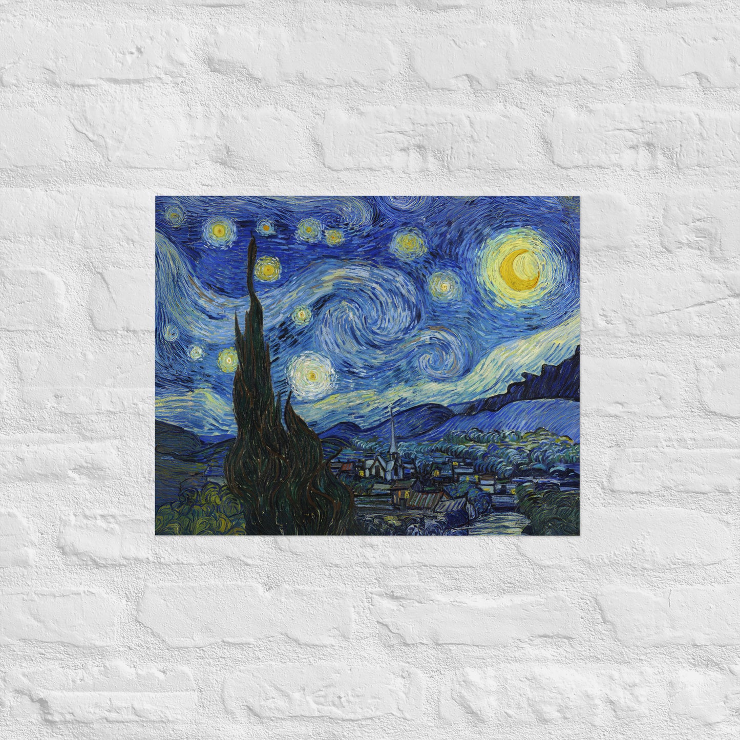 Van Gogh's 'Starry Night' on a 16"x20" unframed poster print on a white brick wall.