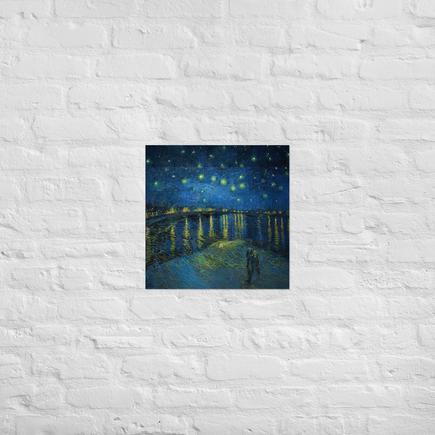 Van Gogh's 'Starry Night Over the Rhone' on a 18"x18" unframed poster print on a white brick wall.