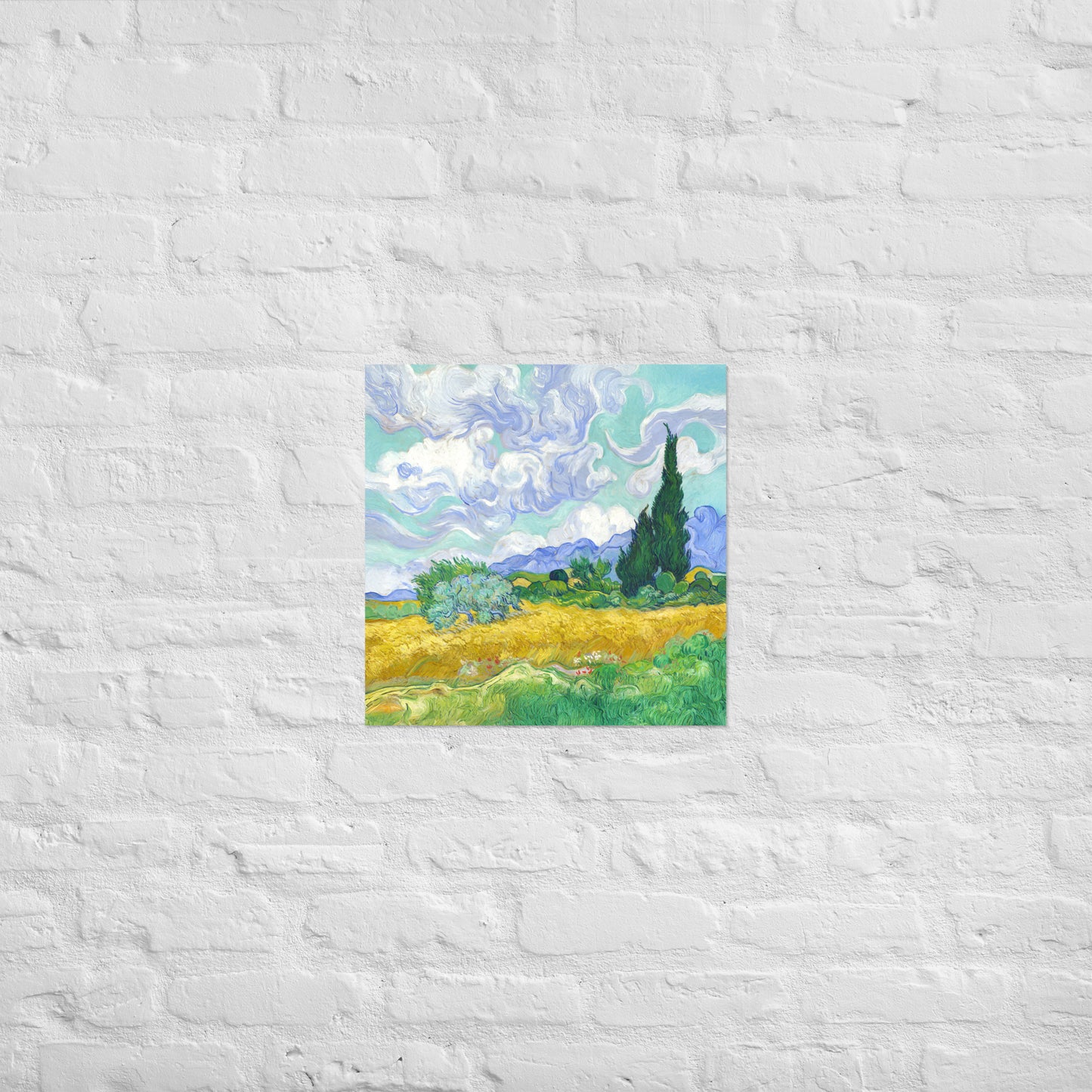 Van Gogh's 'Wheat Field with Cypresses' on a 18"x18" unframed poster print on a white brick wall.