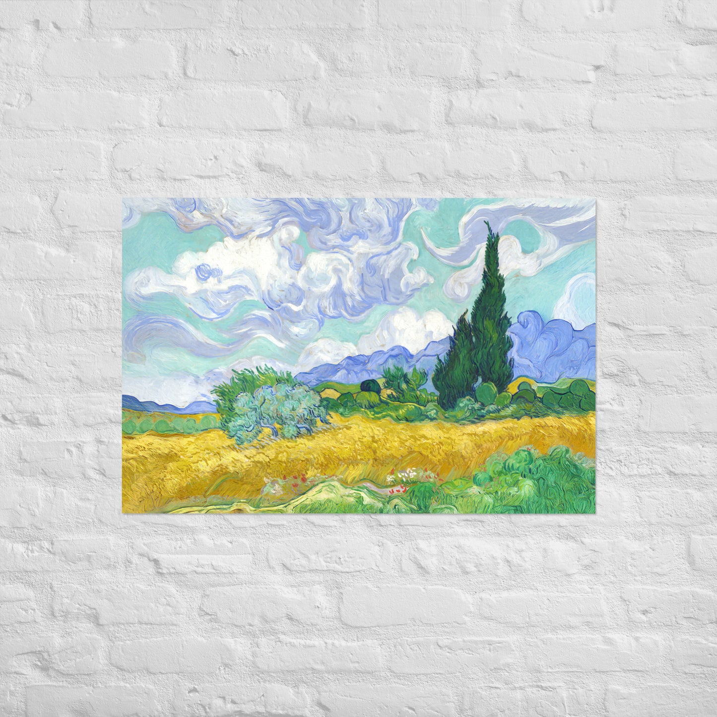 Van Gogh's 'Wheat Field with Cypresses' on a 24"x36" unframed poster print on a white brick wall.