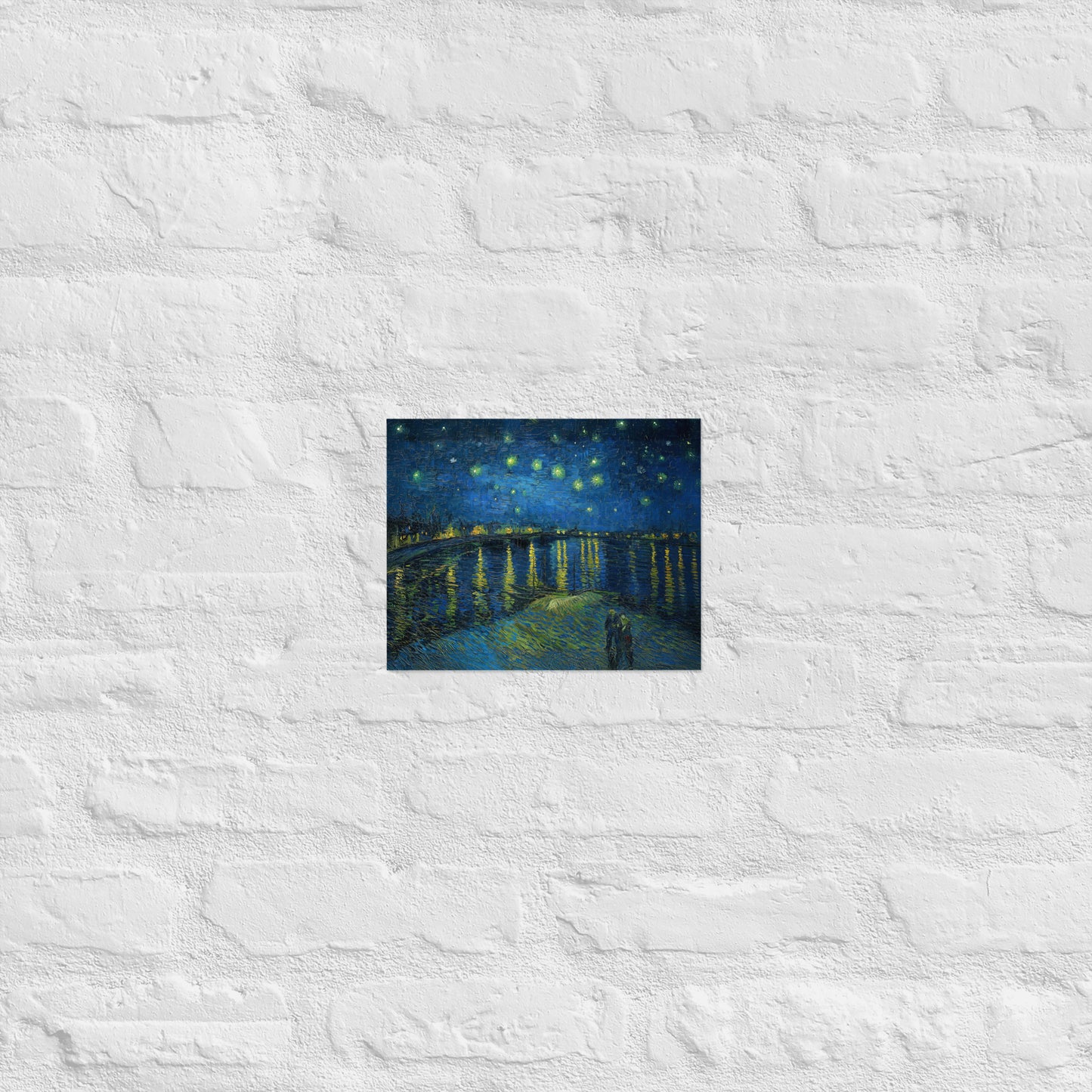 Van Gogh's 'Starry Night Over the Rhone' on a 8"x10" unframed poster print on a white brick wall.