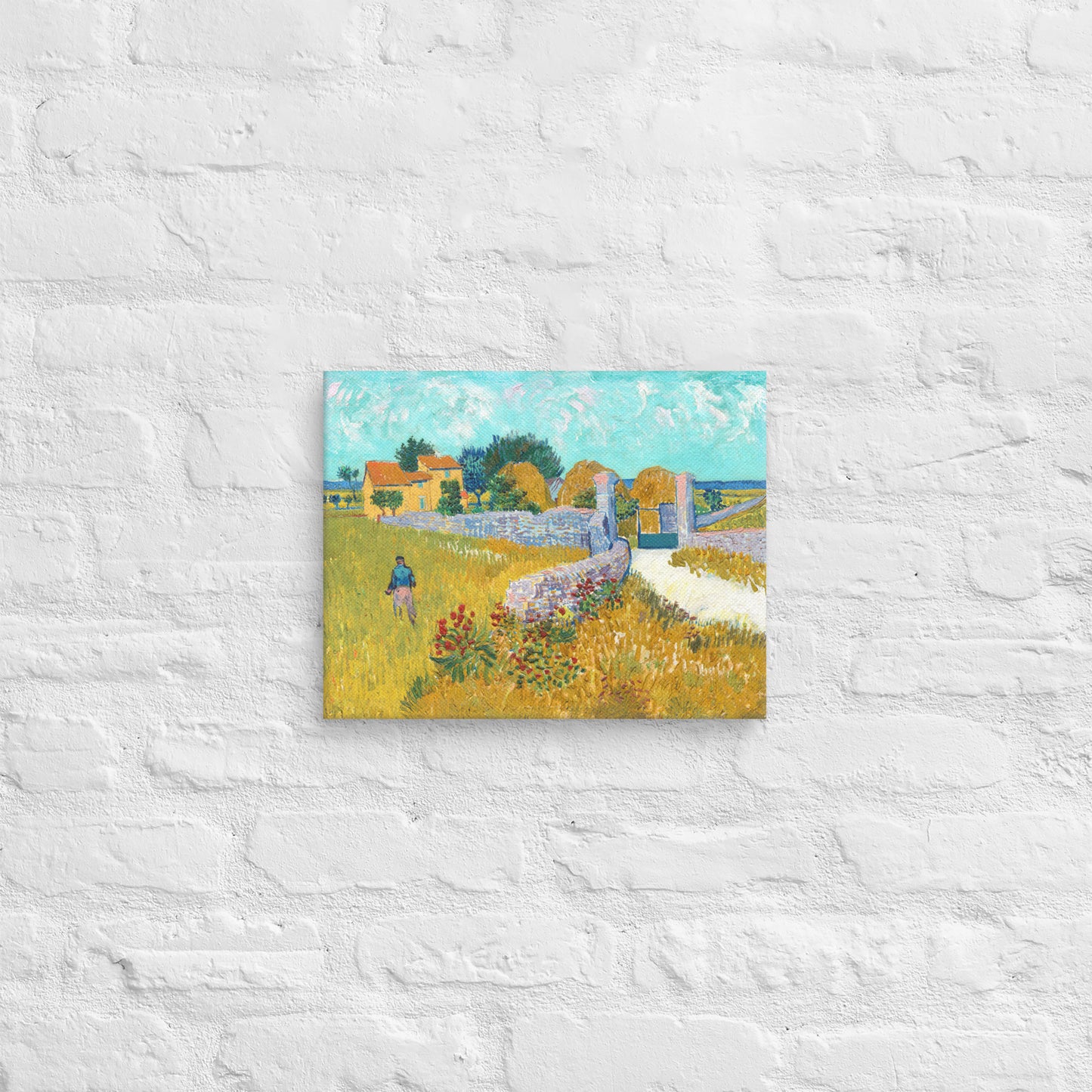 Van Gogh's 'Farmhouse in Provence' on a 11"x14" unframed canvas print on a white brick wall.