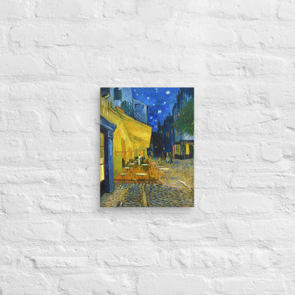 Van Gogh's 'Café Terrace at Night' on a 11"x14" unframed canvas print on a white brick wall.