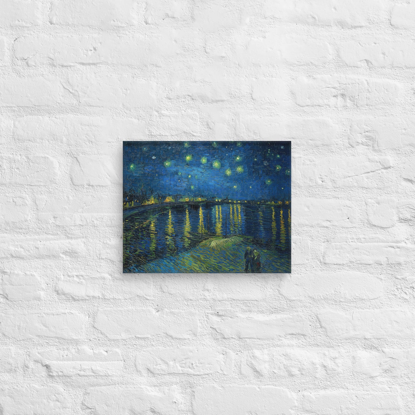Van Gogh's 'Starry Night Over the Rhone' on a 11"x14" unframed canvas print on a white brick wall.