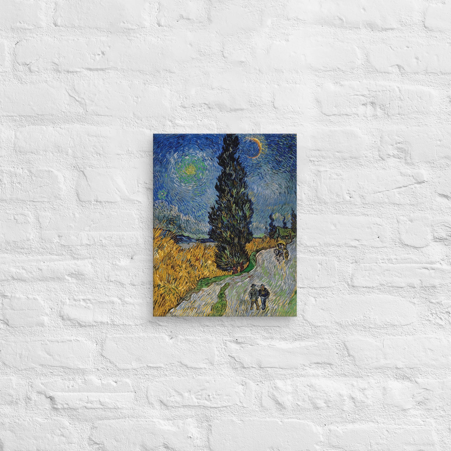 Van Gogh's 'Road with Cypress and Star' on a 11"x14" unframed canvas print on a white brick wall.