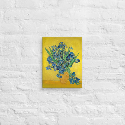 Van Gogh's 'Vase with Irises Against a Yellow Background' on a 11"x14" unframed canvas print on a white brick wall.