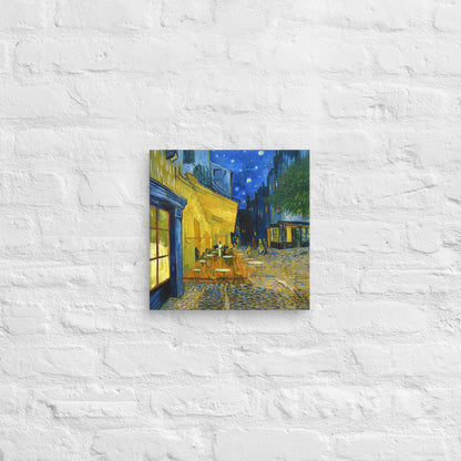 Van Gogh's 'Café Terrace at Night' on a 12"x12" unframed canvas print on a white brick wall.