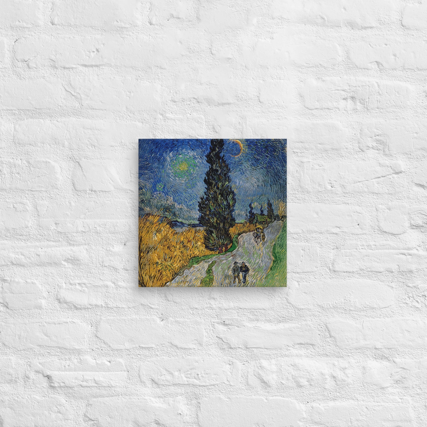 Van Gogh's 'Road with Cypress and Star' on a 12"x12" unframed canvas print on a white brick wall.