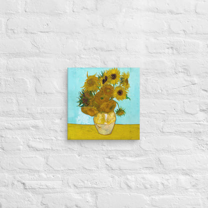 Van Gogh's 'Vase with Twelve Sunflowers' on a 12"x12" unframed canvas print on a white brick wall.