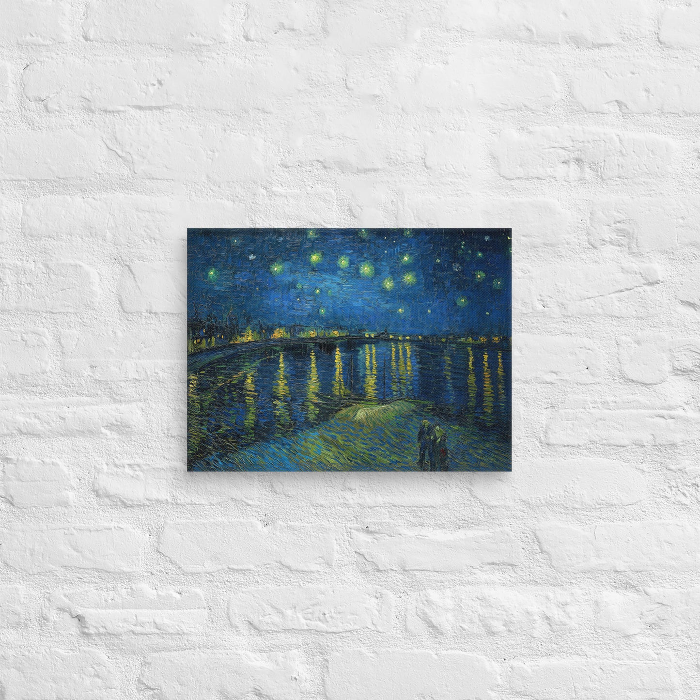 Van Gogh's 'Starry Night Over the Rhone' on a 12"x16" unframed canvas print on a white brick wall.