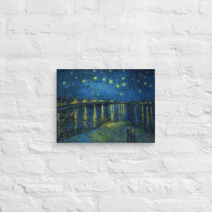 Van Gogh's 'Starry Night Over the Rhone' on a 12"x16" unframed canvas print on a white brick wall.