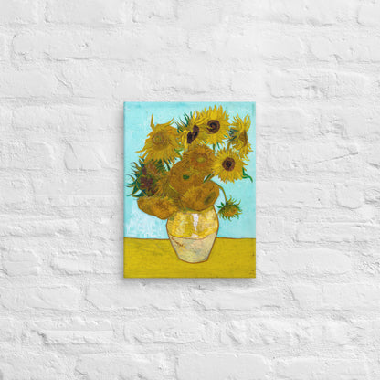 Van Gogh's 'Vase with Twelve Sunflowers' on a 12"x16" unframed canvas print on a white brick wall.