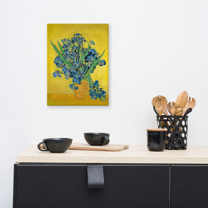 Van Gogh's 'Vase with Irises Against a Yellow Background' on a 12"x16" unframed canvas print on a white wall above a kitchen counter with cooking supplies.