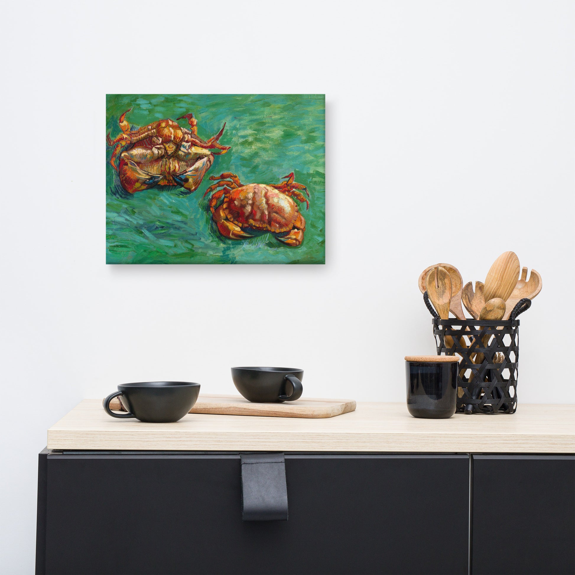 Van Gogh's 'Two Crabs' on a 12"x16" unframed canvas print on a white wall above a kitchen counter with cooking supplies.