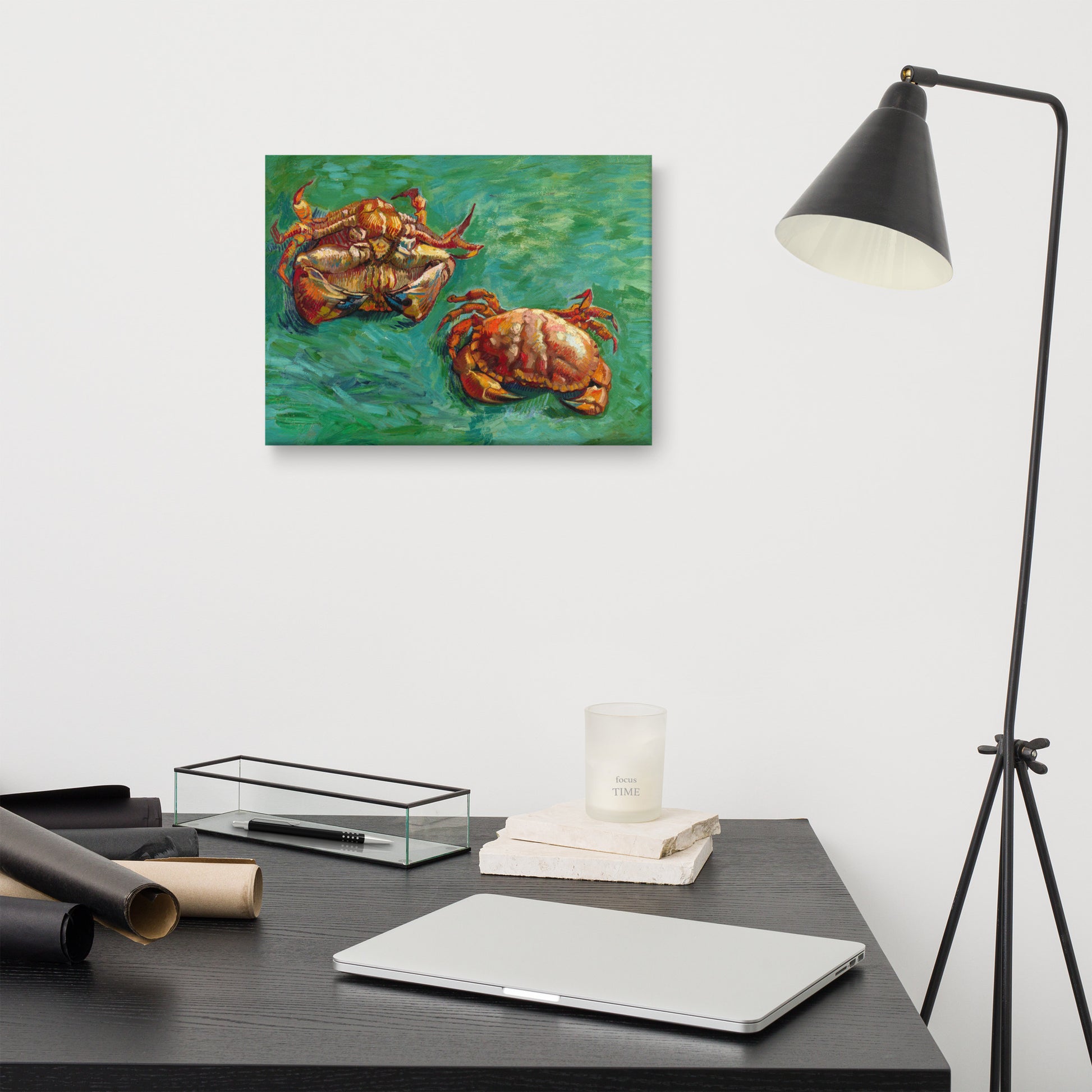 Van Gogh's 'Two Crabs' on a 12"x16" unframed canvas print on a white wall above a modern office desk, lamp, and assorted desk items.