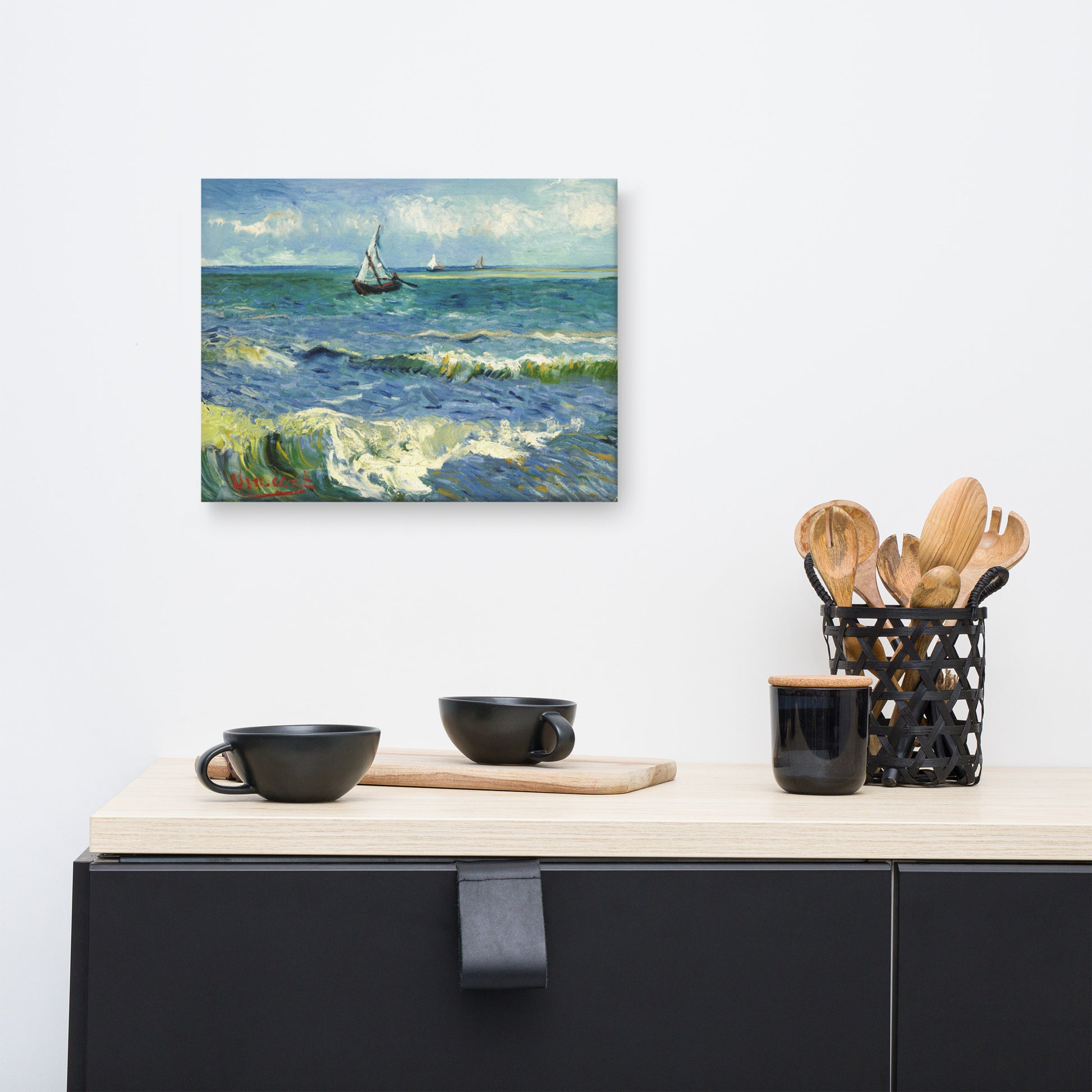Van Gogh's 'The Sea at Les Saintes-Maries-de-la-Mer' on a 12"x16" unframed canvas print on a white wall above a kitchen counter with cooking supplies.