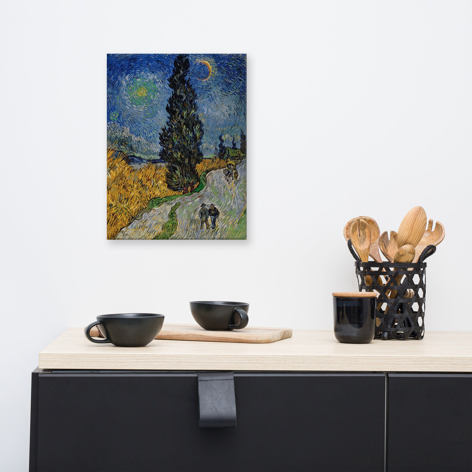Van Gogh's 'Road with Cypress and Star' on a 12"x16" unframed canvas print on a white wall above a kitchen counter with cooking supplies.