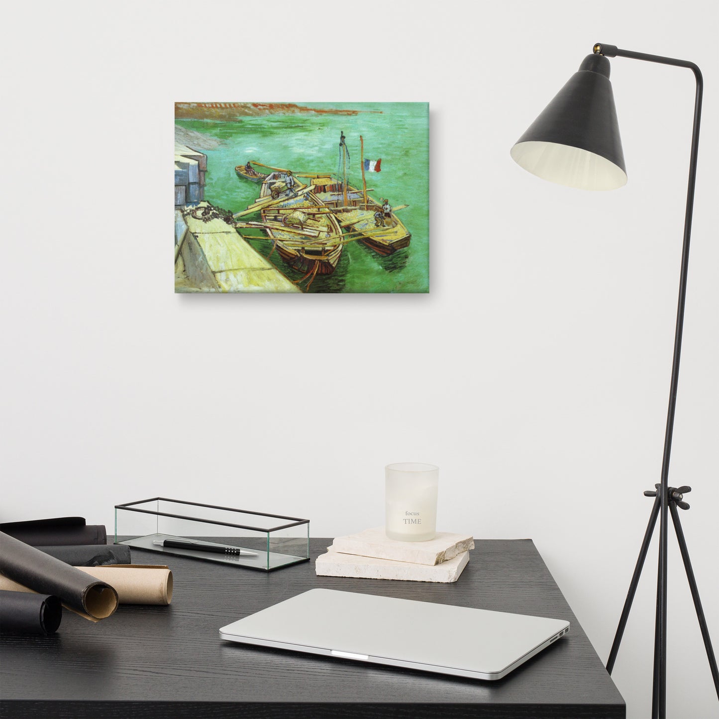 Van Gogh's 'Quay with Men Unloading Sand Barges' on a 12"x16" unframed canvas print on a white wall above a kitchen counter with cooking supplies.