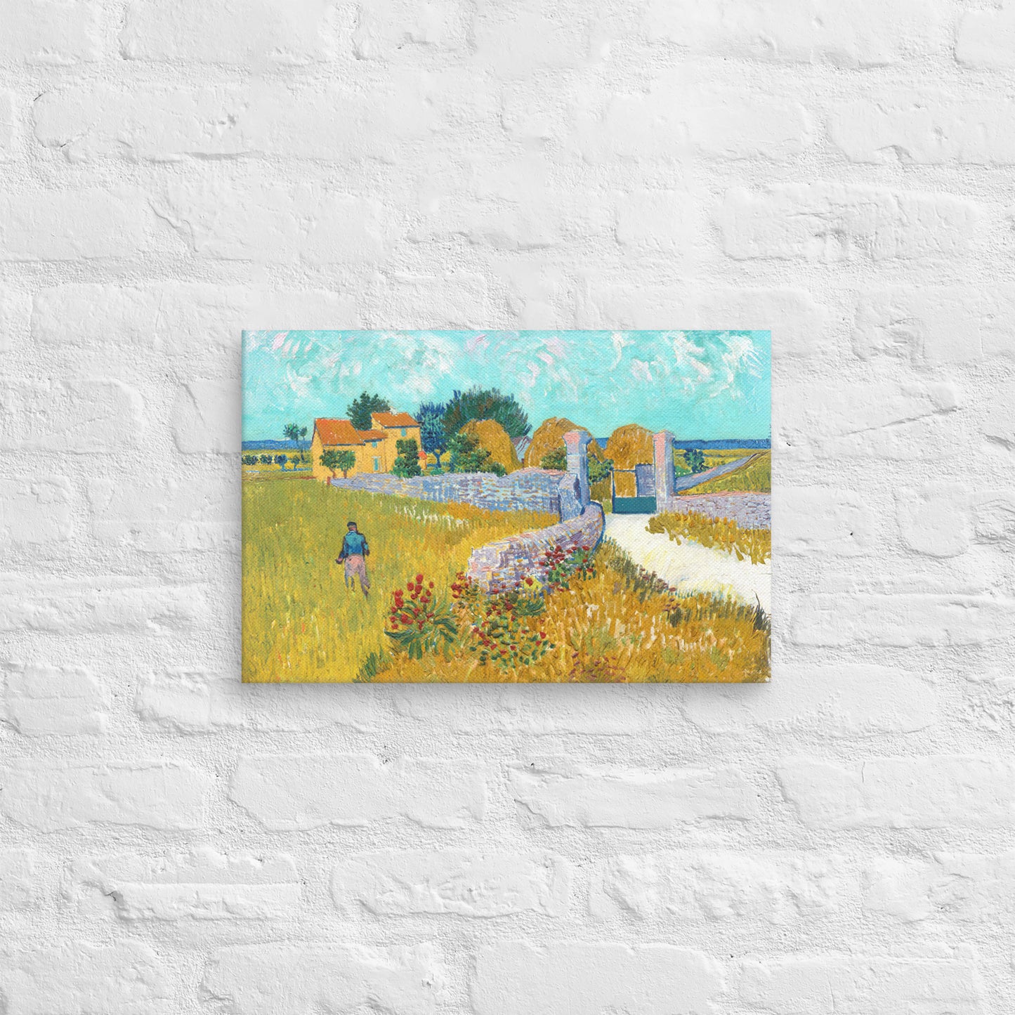 Van Gogh's 'Farmhouse in Provence' on a 12"x18" unframed canvas print on a white brick wall.