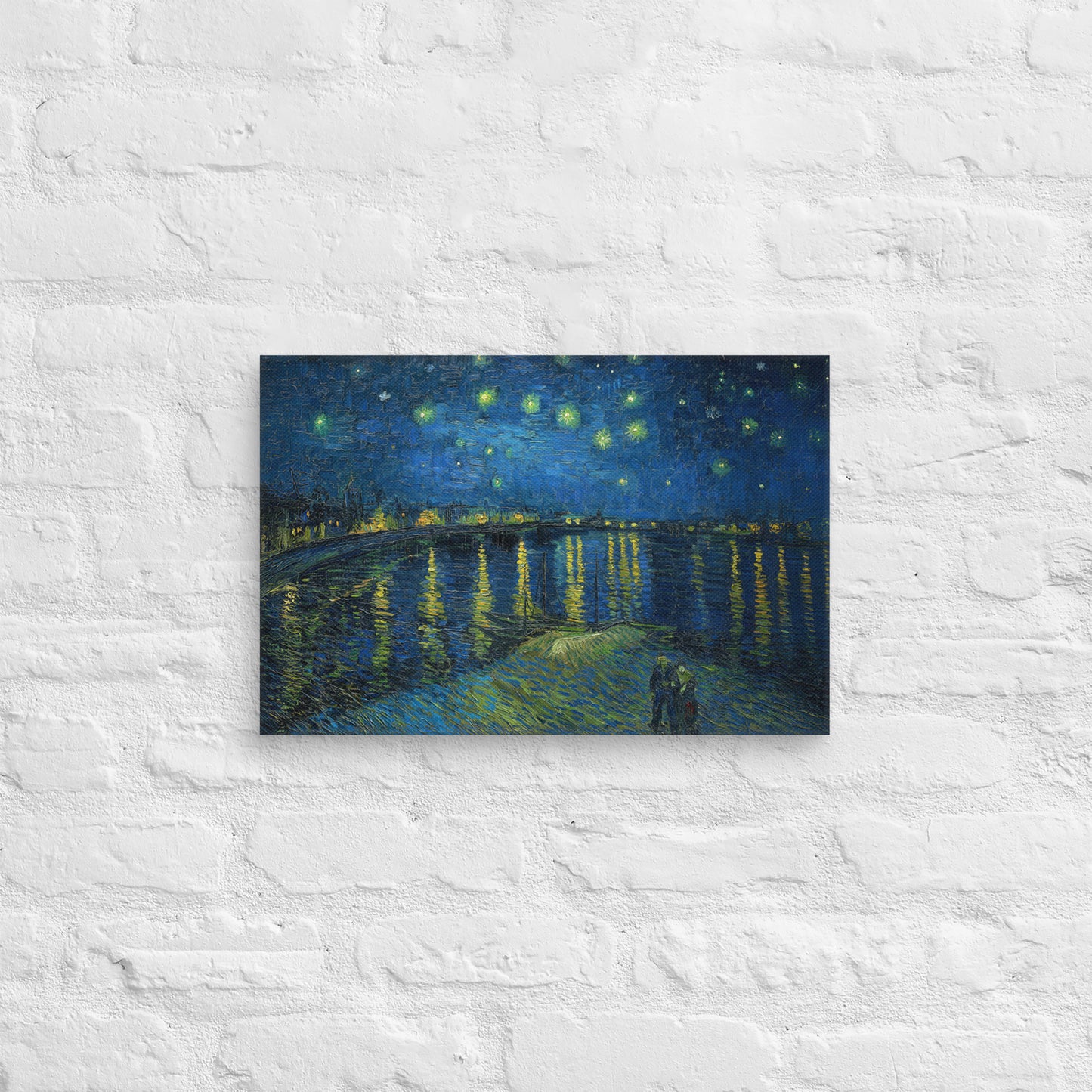 Van Gogh's 'Starry Night Over the Rhone' on a 12"x18" unframed canvas print on a white brick wall.