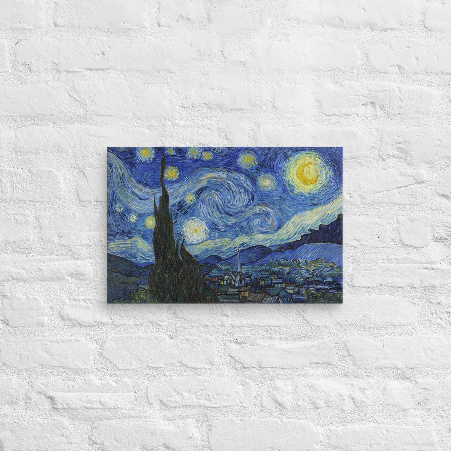 Van Gogh's 'Starry Night' on a 12"x18" unframed canvas print on a white brick wall.