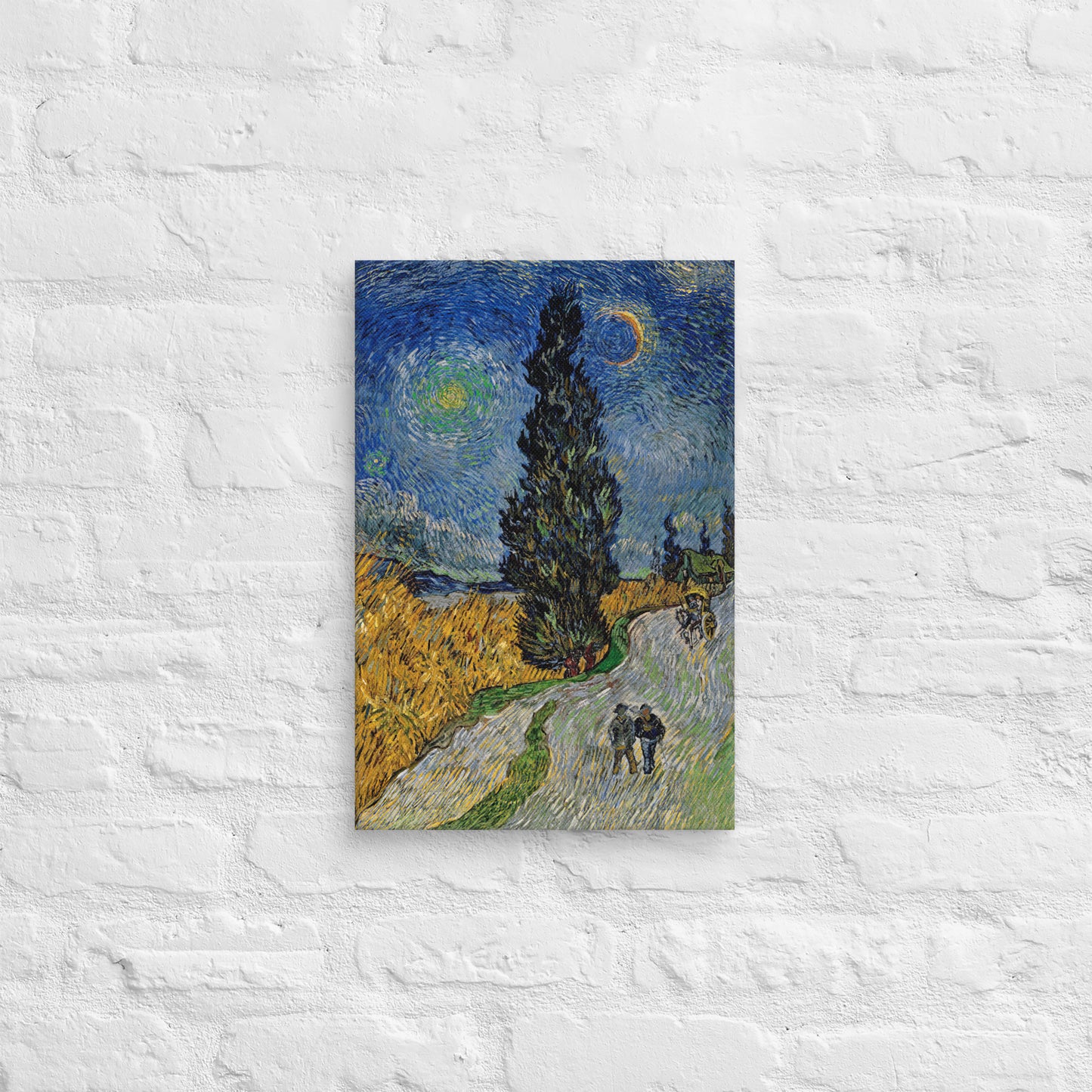 Van Gogh's 'Road with Cypress and Star' on a 12"x18" unframed canvas print on a white brick wall.