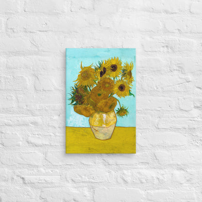 Van Gogh's 'Vase with Twelve Sunflowers' on a 12"x18" unframed canvas print on a white brick wall.