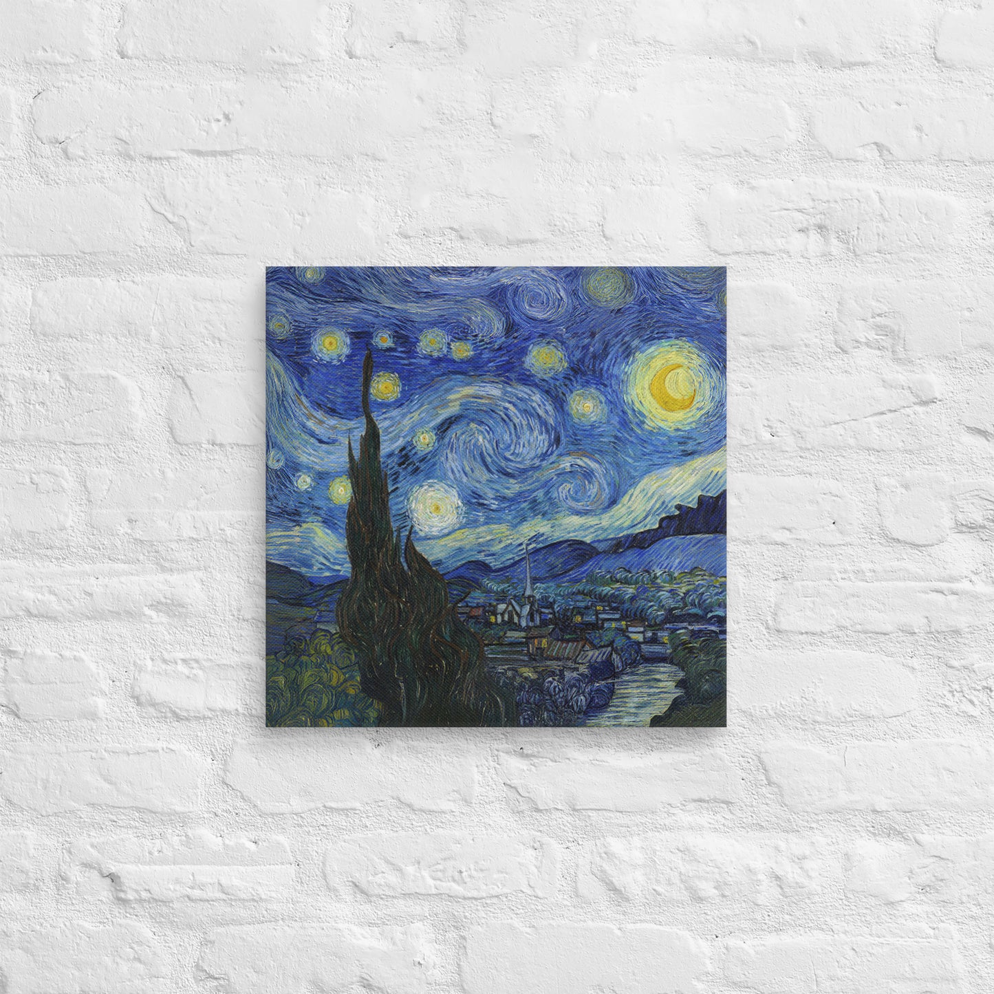Van Gogh's 'Starry Night' on a 16"x16" unframed canvas print on a white brick wall.