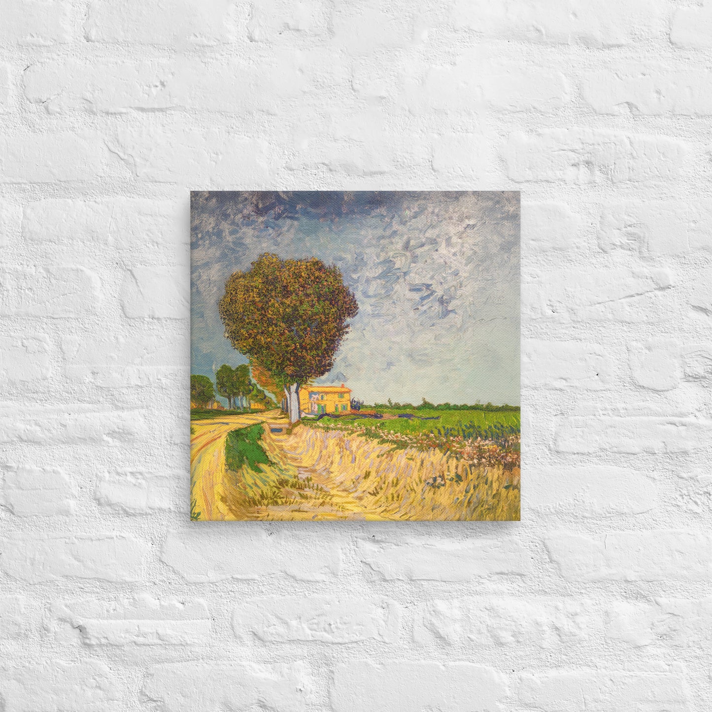 Van Gogh's 'A Lane near Arles' on a 16"x16" unframed canvas print on a white brick wall.