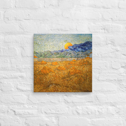 Van Gogh's 'Landscape with Wheat Sheaves and Rising Moon' on a 16"x16" unframed canvas print on a white brick wall.