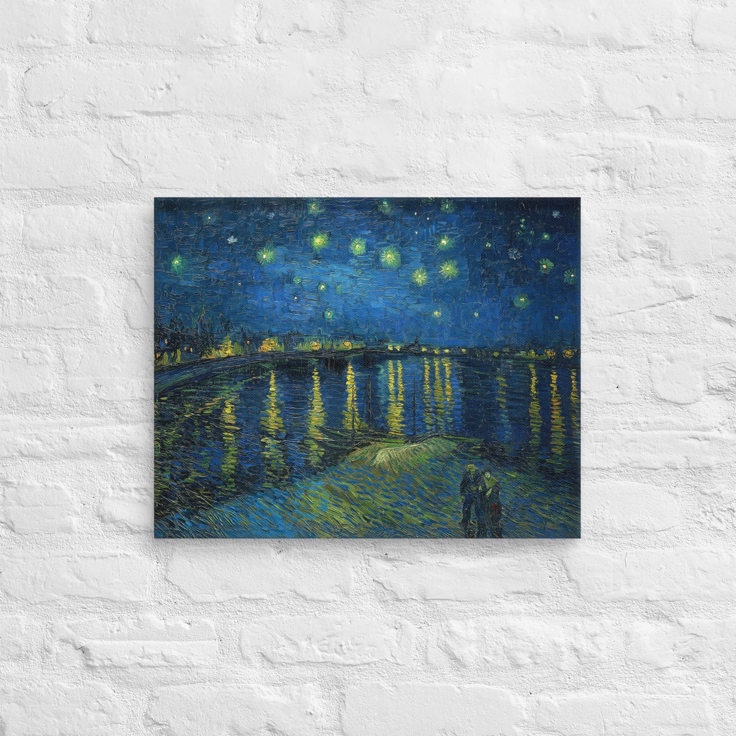 Van Gogh's 'Starry Night Over the Rhone' on a 16"x20" unframed canvas print on a white brick wall.