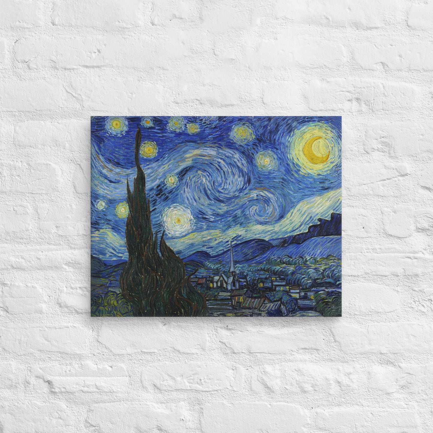 Van Gogh's 'Starry Night' on a 16"x20" unframed canvas print on a white brick wall.