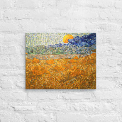 Van Gogh's 'Landscape with Wheat Sheaves and Rising Moon' on a 16"x20" unframed canvas print on a white brick wall.