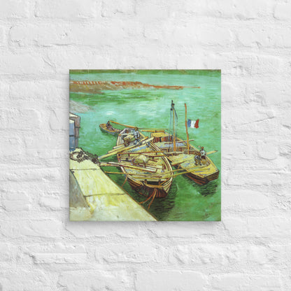 Van Gogh's 'Quay with Men Unloading Sand Barges' on a 18"x18" unframed canvas print on a white brick wall.