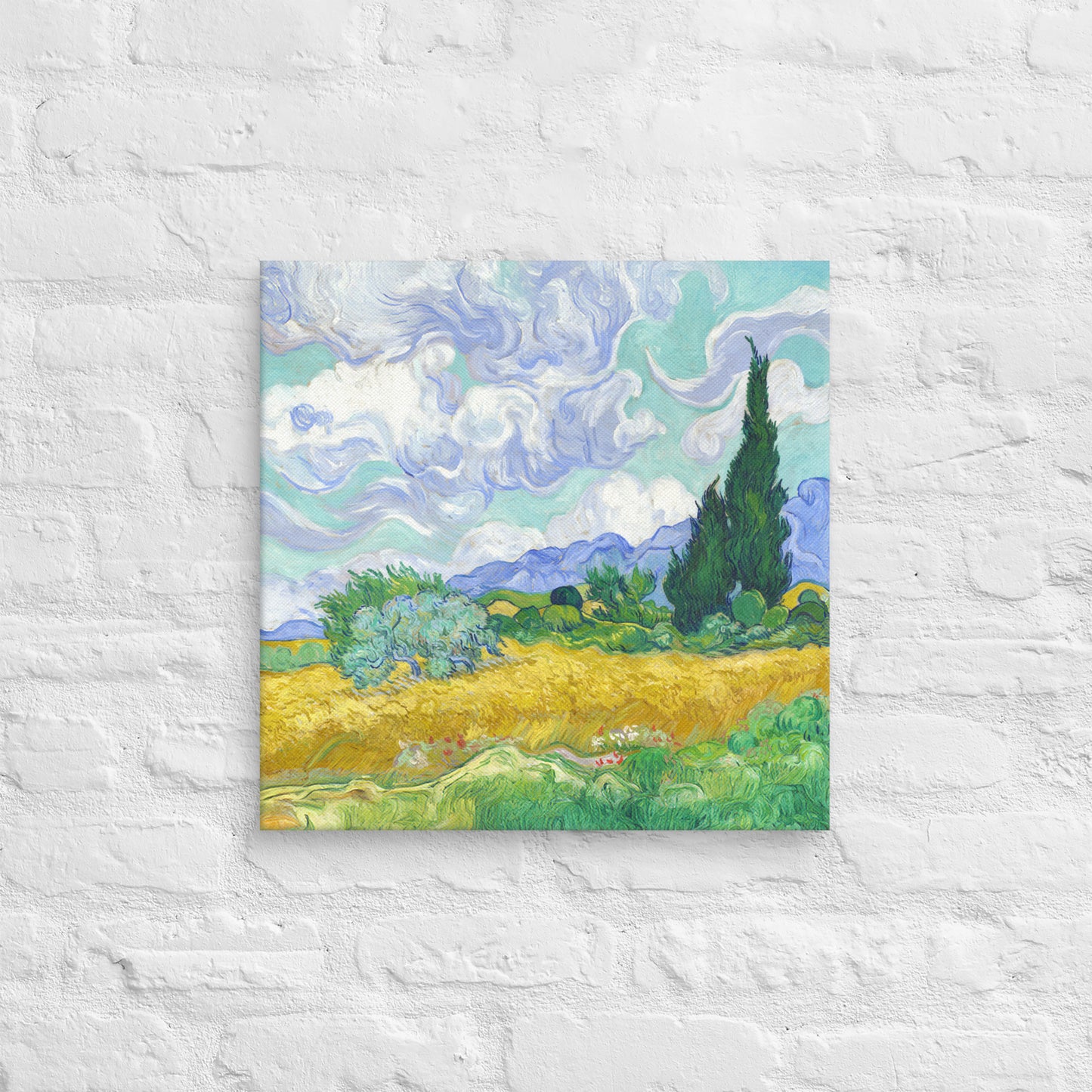 Van Gogh's 'Wheat Field with Cypresses' on a 18"x18" unframed canvas print on a white brick wall.