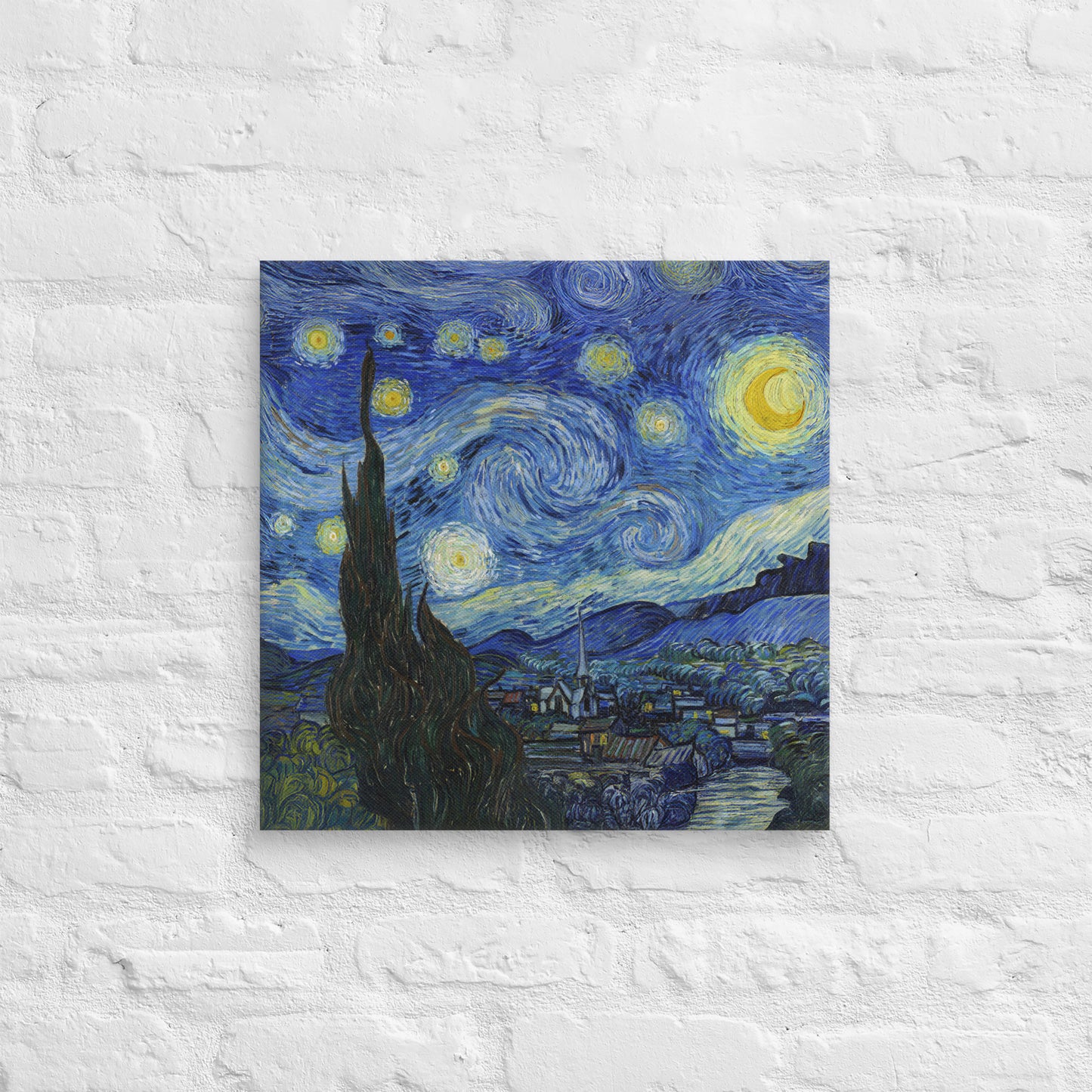 Van Gogh's 'Starry Night' on a 18"x18" unframed canvas print on a white brick wall.