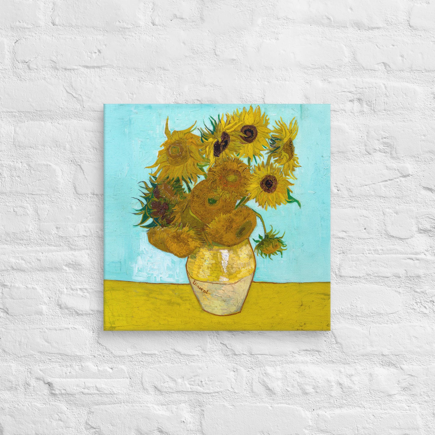 Van Gogh's 'Vase with Twelve Sunflowers' on a 18"x18" unframed canvas print on a white brick wall.