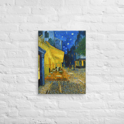 Van Gogh's 'Café Terrace at Night' on a 18"x24" unframed canvas print on a white brick wall.