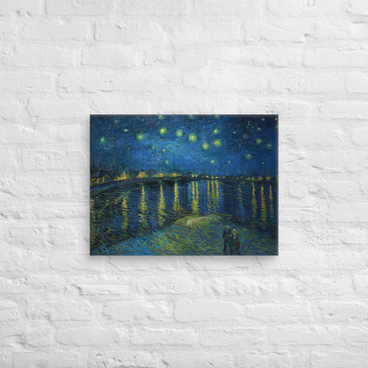 Van Gogh's 'Starry Night Over the Rhone' on a 18"x24" unframed canvas print on a white brick wall.