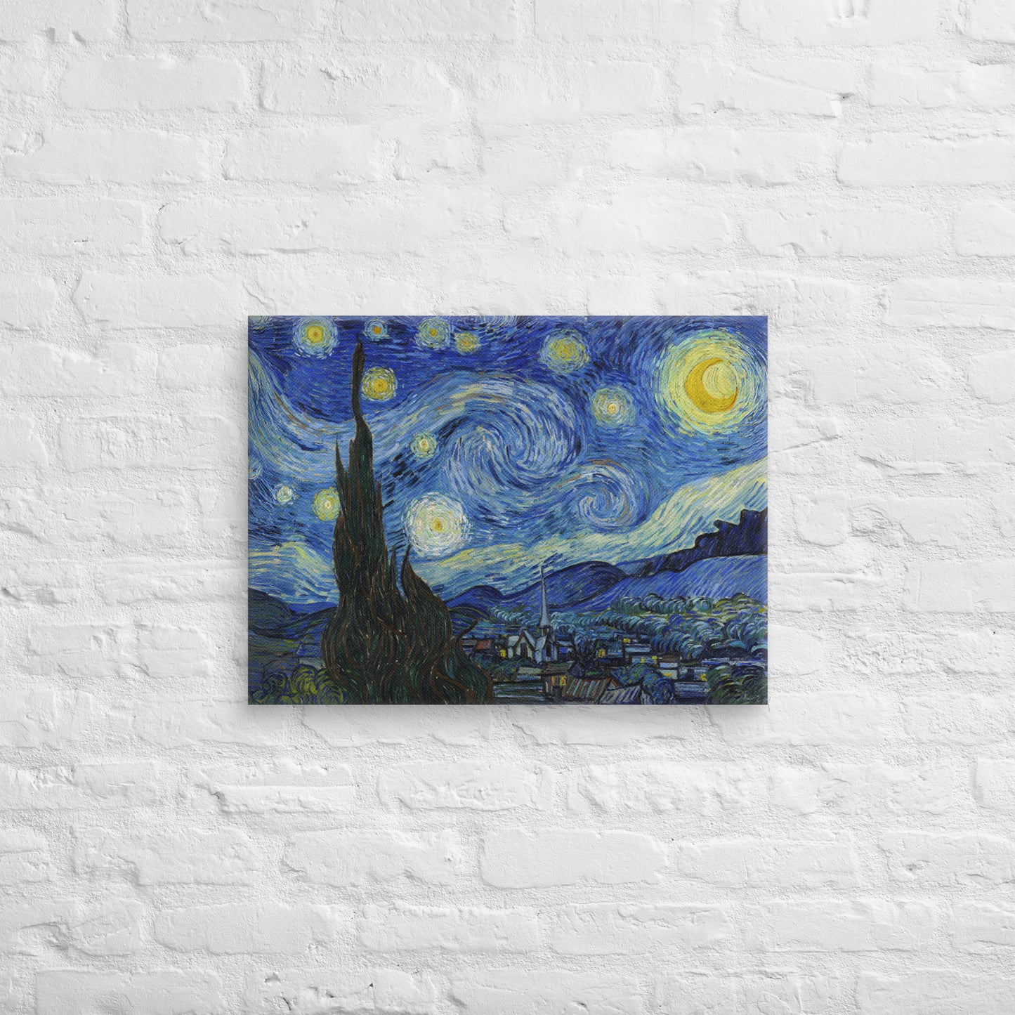 Van Gogh's 'Starry Night' on a 18"x24" unframed canvas print on a white brick wall.