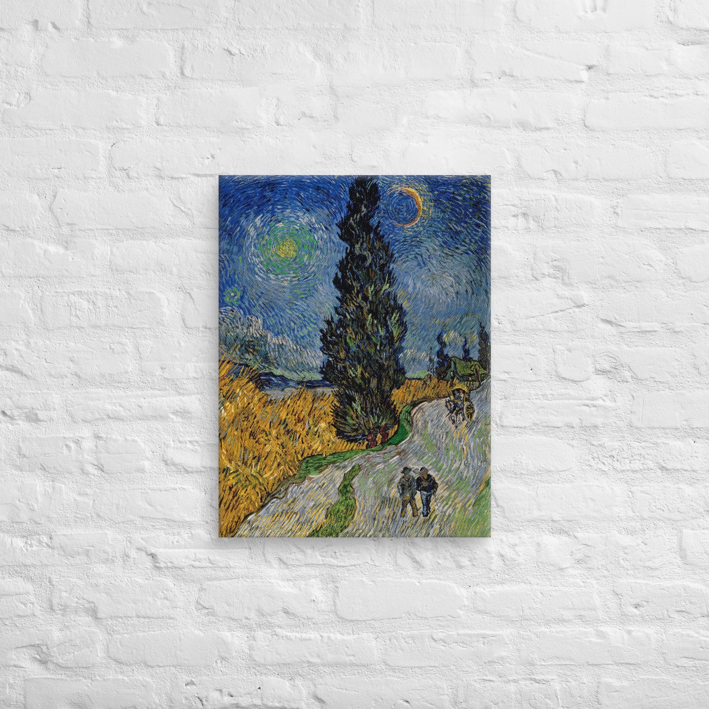 Van Gogh's 'Road with Cypress and Star' on a 18"x24" unframed canvas print on a white brick wall.